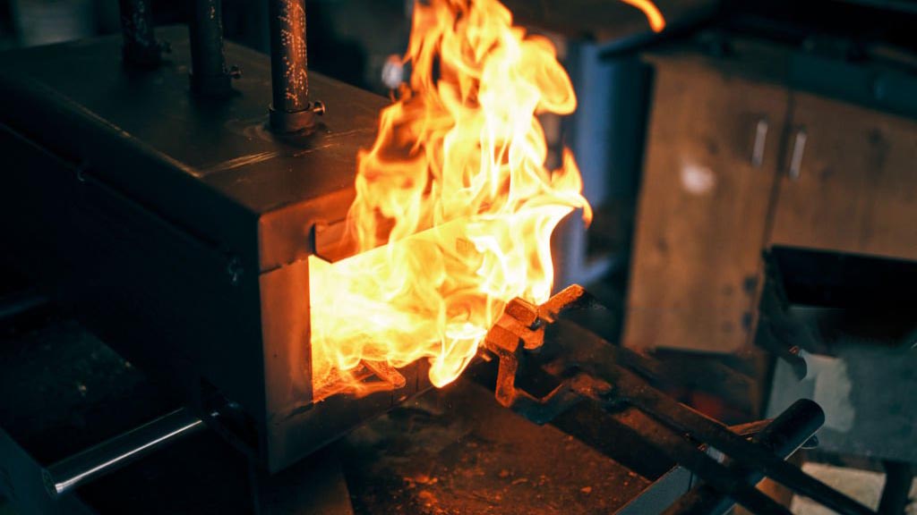 An infographic showing a bar of stainless steel entering a forge