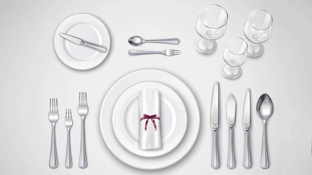 A perfectly and correctly laid table setting, showing forks left, knives and spoons right