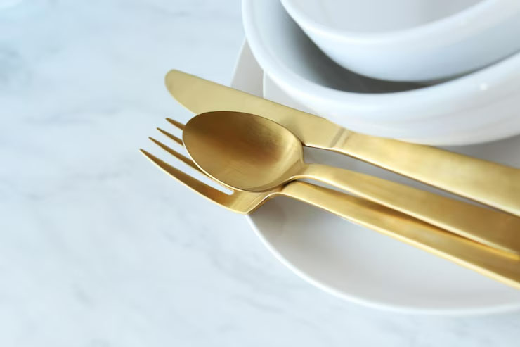 A black titanium fork from years ago next to a brand new one, showing minimal signs of wear