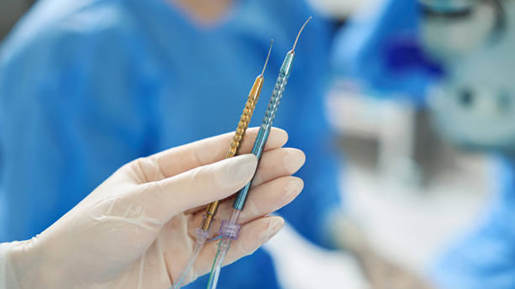 A clean piece of black titanium flatware next to a medical-grade titanium hip implant