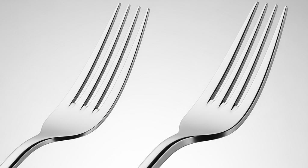 A close-up image highlighting the thick bolster on a forged fork next to a flat stamped fork