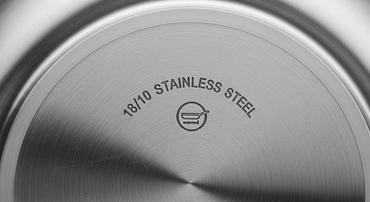 A close-up of a product stamp on the bottom of a pan that says '18/10 Stainless Steel 316'