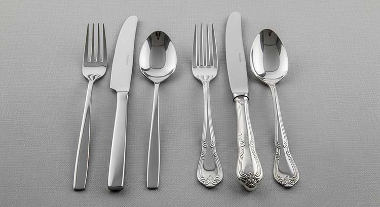 A modern minimalist cutlery set next to a classic, ornate set, showing different styles