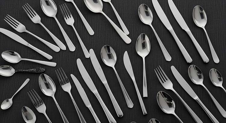 A collection of stainless steel flatware with different finishes and grades