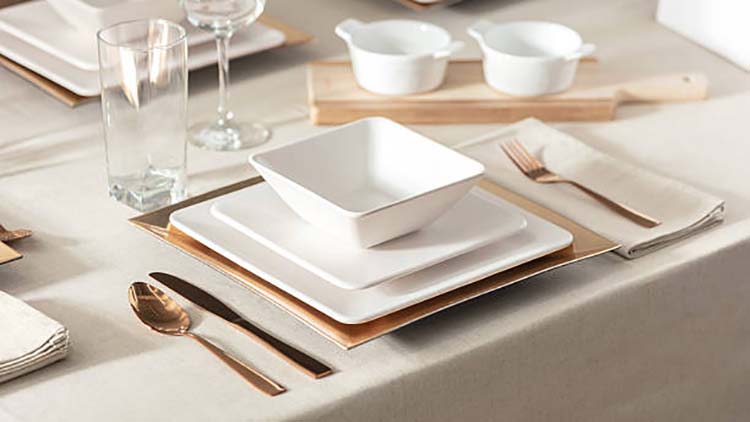A set of elegant rose gold cutlery on a table