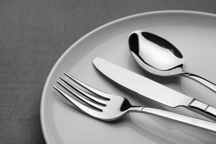 Different grades of stainless steel flatware displayed side-by-side