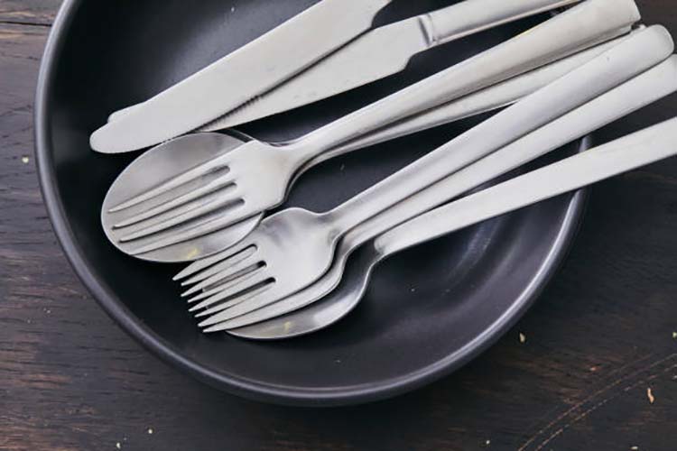 Shiny forks and spoons made from different stainless steel grades