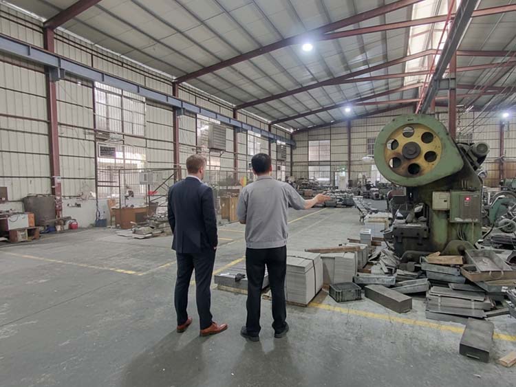 A detailed photo of a sample cutlery set being examined for finish, weight, and ergonomics