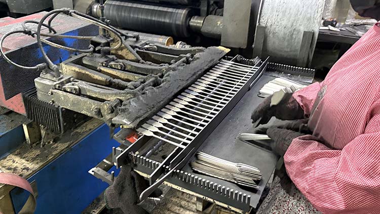 A quality control inspector examining stainless steel forks with a caliper