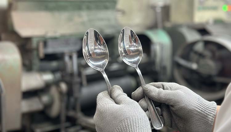 A side-by-side comparison of a machine-polished spoon and a hand-polished spoon