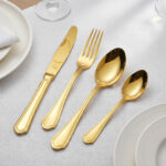 Gold finish detail on stainless steel knife and fork set