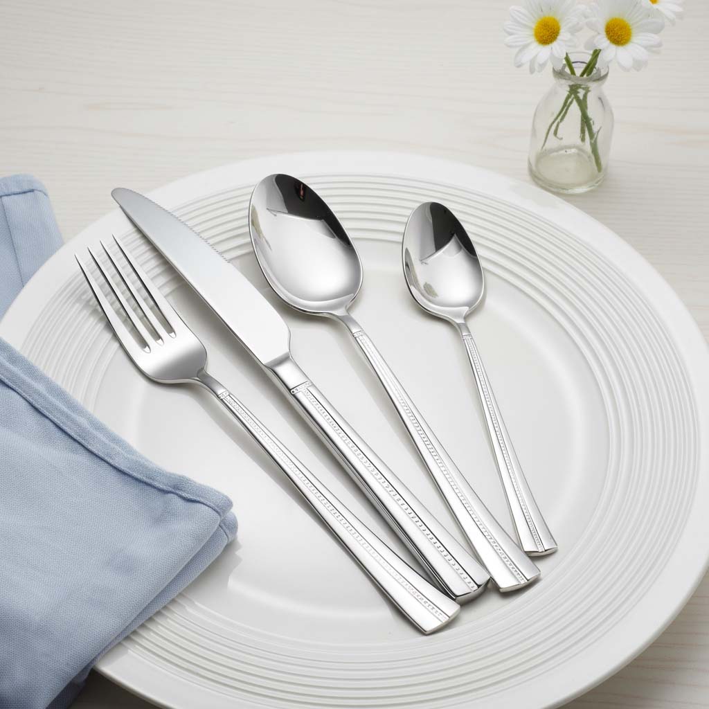 Decorative beaded edge detail on stainless steel spoon fork knife set