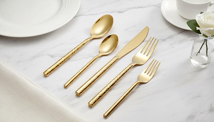 A close-up of a textured coining die used to press a hammered pattern onto a handle