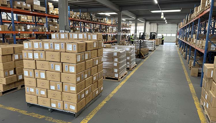 A large, organized warehouse at XR Cutlery with boxes ready for shipping
