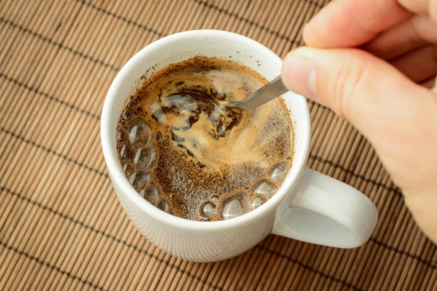 Coffee Spoon in Use A coffee spoon stirring a small cup of espresso.