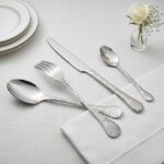 Textured hammered surface detail on stainless steel spoon fork knife set