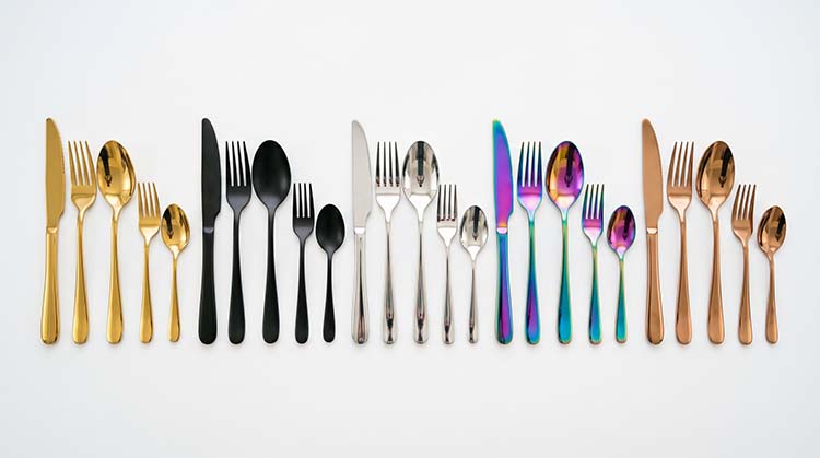 A display of flatware in various PVD colors like gold, black, and rose gold