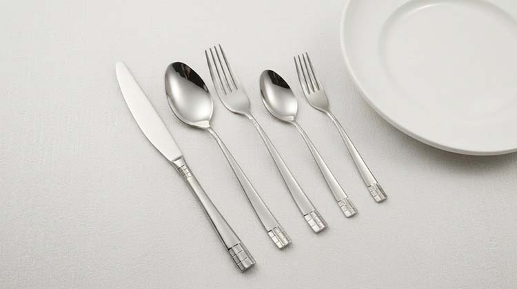 Close-up of an ergonomic flatware handle design being held comfortably in a hand